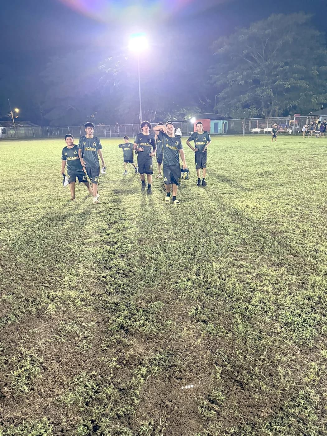 Young players in Arcadia jerseys on the lit field