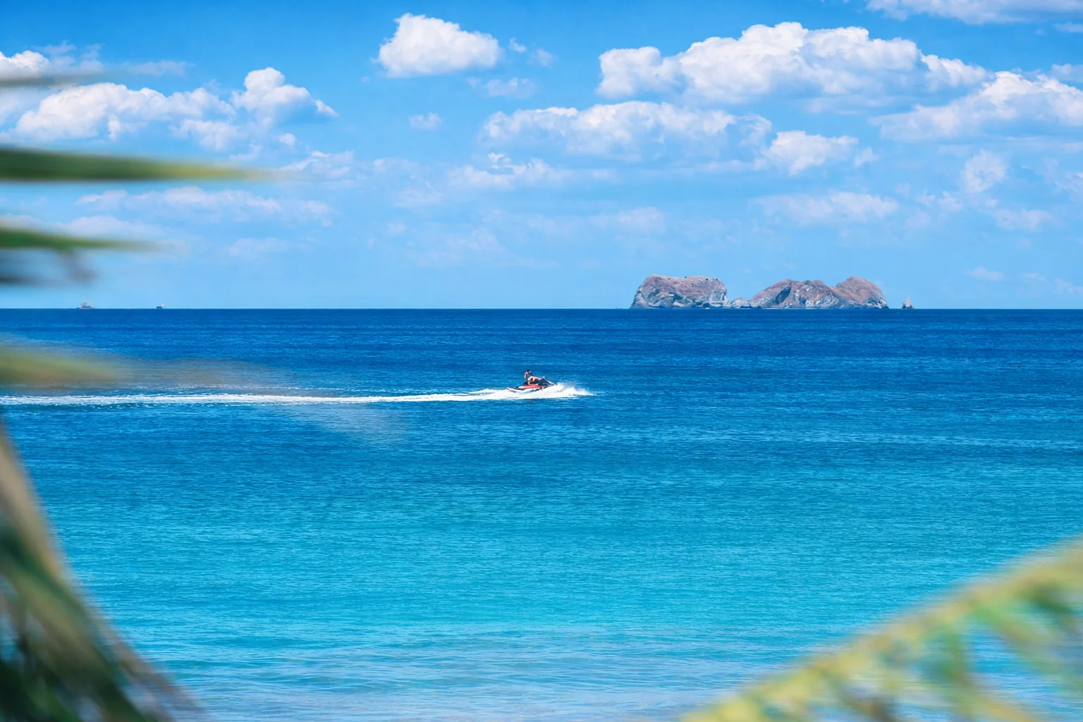 Jet ski and water sports on Brasilito beach illustrating vacation rental demand in Guanacaste